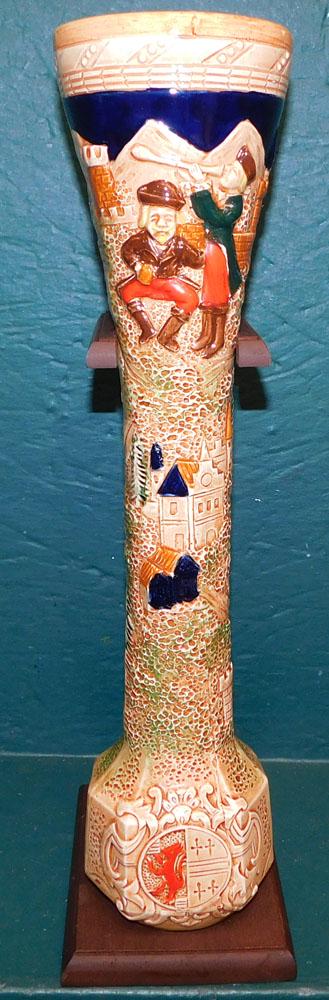 Porcelain Beer Stein On Wood Stand: Porcelain Beer Stein On Wood Stand. 19" H ALL DESCRIPTIONS AND ANY CONDITION STATEMENT GIVEN BY LANGSTON AUCTION GALLERY ARE STRICTLY OPINIONS AND LANGSTON'S SHALL HAVE NO RESPONSIBILITY FOR ERRORS OR