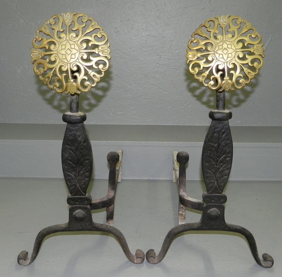 Pr. wrought iron andirons w/ brass sunburst front: Pair of wrought iron andirons with brass sunburst front from a Wilson estate. 23" h.