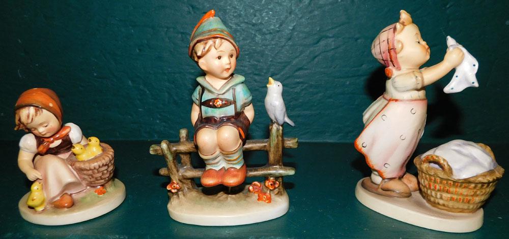 3 Hummel Figurines: 3 Hummel Figurines . Up to 5 3/4" H ALL DESCRIPTIONS AND ANY CONDITION STATEMENT GIVEN BY LANGSTON AUCTION GALLERY ARE STRICTLY OPINIONS AND LANGSTON'S SHALL HAVE NO RESPONSIBILITY FOR ERRORS OR OMISS