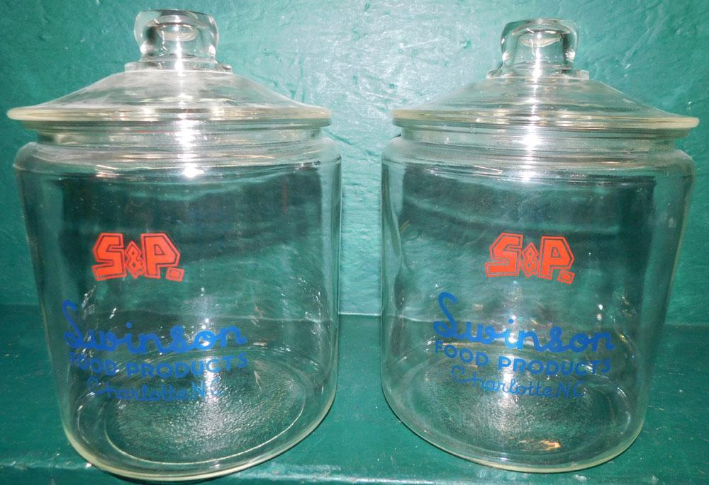 Pair Glass Swanson Candy Jars: Pair Glass Swanson Candy Jars. 10" H ALL DESCRIPTIONS AND ANY CONDITION STATEMENT GIVEN BY LANGSTON AUCTION GALLERY ARE STRICTLY OPINIONS AND LANGSTON'S SHALL HAVE NO RESPONSIBILITY FOR ERRORS OR OMIS