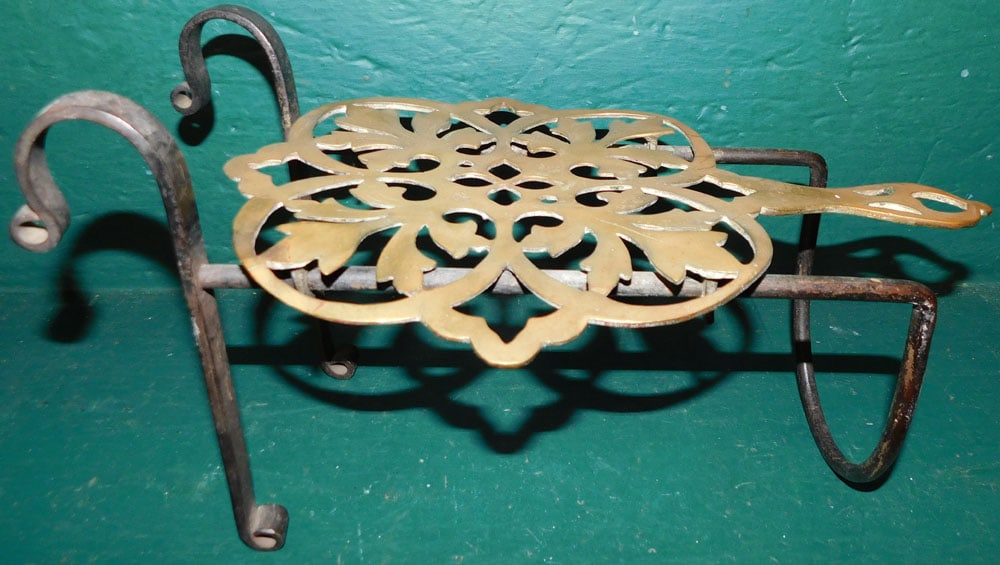 Antique Wrought Iron & Brass Trivet: Antique Wrought Iron & Brass Trivet . 14" x 8" "ALL DESCRIPTIONS AND ANY CONDITION STATEMENT GIVEN BY LANGSTON AUCTION GALLERY ARE STRICTLY OPINIONS AND LANGSTON'S SHALL HAVE NO RESPONSIBILITY FOR ERR