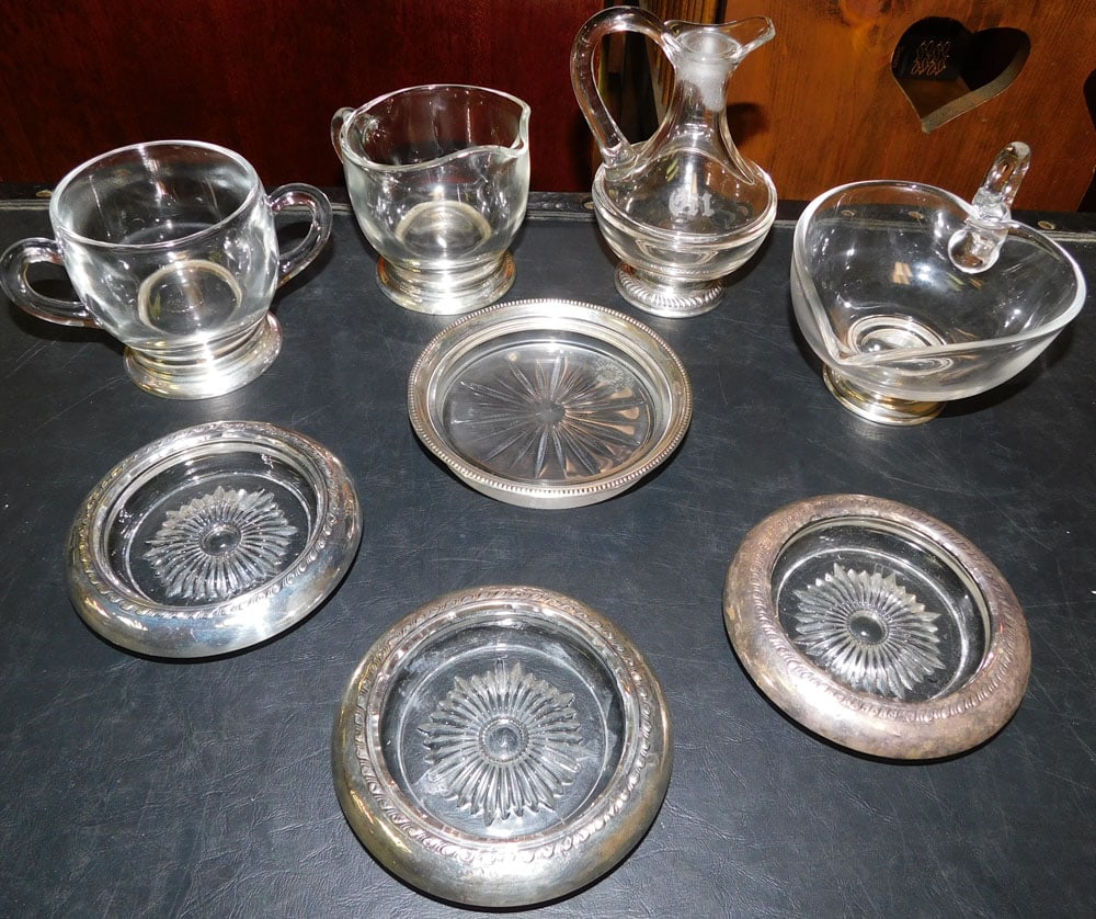 Sterling Rimmed Sugar, Creamer, & Oil Cruet, Sterling Rimmed Coasters, & Sterling Edge Wine Coaster: Sterling Rimmed Sugar, Creamer, & Oil Cruet, Sterling Rimmed Coasters, & Sterling Edge Wine Coaster. Up to 5 1/2" H ALL DESCRIPTIONS AND ANY CONDITION STATEMENT GIVEN BY LANGSTON AUCTION GALLERY ARE S