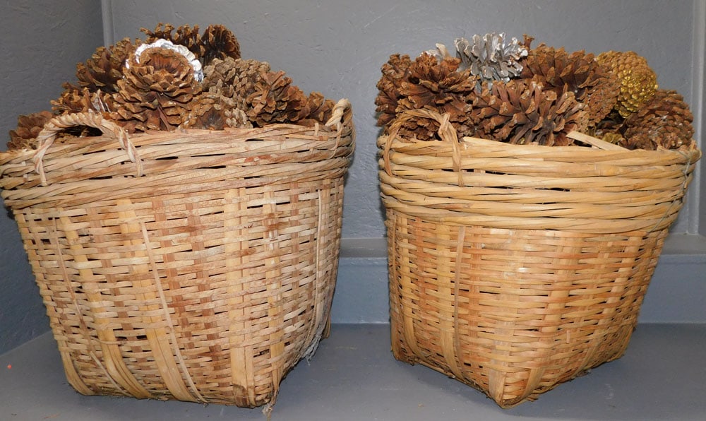Pair Bamboo Baskets With Pine Cones: Pair Bamboo Baskets With Pine Cones. 25" Dia 19" H ALL DESCRIPTIONS AND ANY CONDITION STATEMENT GIVEN BY LANGSTON AUCTION GALLERY ARE STRICTLY OPINIONS AND LANGSTON'S SHALL HAVE NO RESPONSIBILITY FOR 