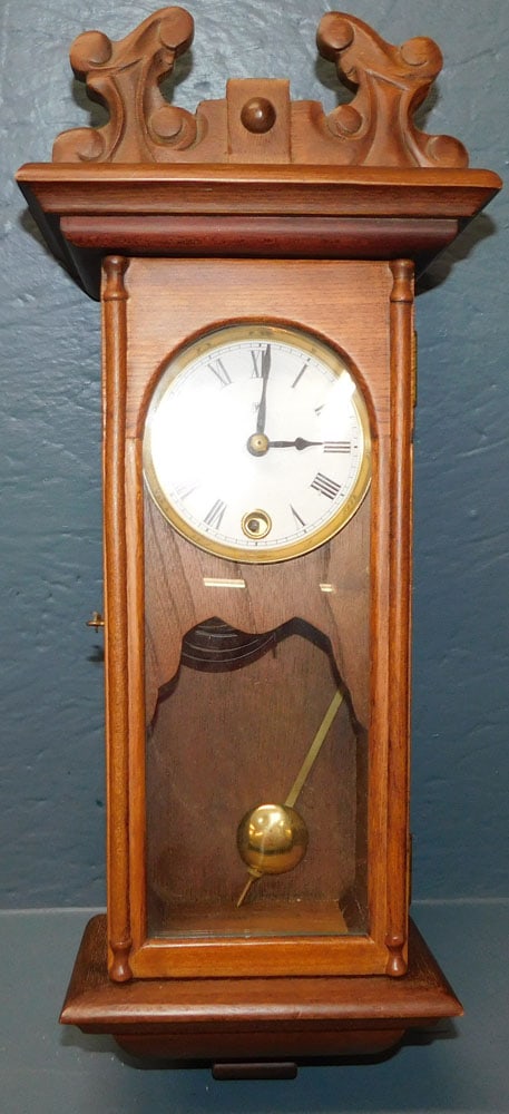 Mahogany Wall Clock: Mahogany Wall Clock. 7 3/4" W 18 1/2" ALL DESCRIPTIONS AND ANY CONDITION STATEMENT GIVEN BY LANGSTON AUCTION GALLERY ARE STRICTLY OPINIONS AND LANGSTON'S SHALL HAVE NO RESPONSIBILITY FOR ERRORS OR OMI