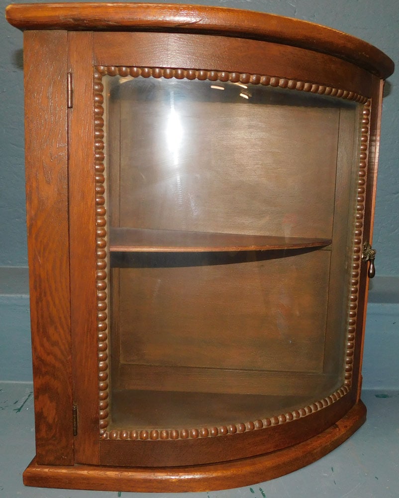 Oak Bow Front Glass Door Cabinet: Oak Bow Front Glass Door Cabinet. 19" W 20 1/4" H ALL DESCRIPTIONS AND ANY CONDITION STATEMENT GIVEN BY LANGSTON AUCTION GALLERY ARE STRICTLY OPINIONS AND LANGSTON'S SHALL HAVE NO RESPONSIBILITY FOR E