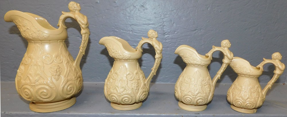 Set 4 Graduated Basalt Pitchers With Figural Handles: Set 4 Graduated Basalt Pitchers With Figural Handles. Up to 9 1/4" H ALL DESCRIPTIONS AND ANY CONDITION STATEMENT GIVEN BY LANGSTON AUCTION GALLERY ARE STRICTLY OPINIONS AND LANGSTON'S SHALL HAVE NO R