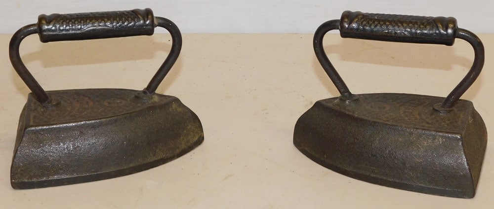Two Cast Iron Sadd Irons: Two Cast Iron Sadd Irons. 5" H ALL DESCRIPTIONS AND ANY CONDITION STATEMENT GIVEN BY LANGSTON AUCTION GALLERY ARE STRICTLY OPINIONS AND LANGSTON'S SHALL HAVE NO RESPONSIBILITY FOR ERRORS OR OMISSIONS.