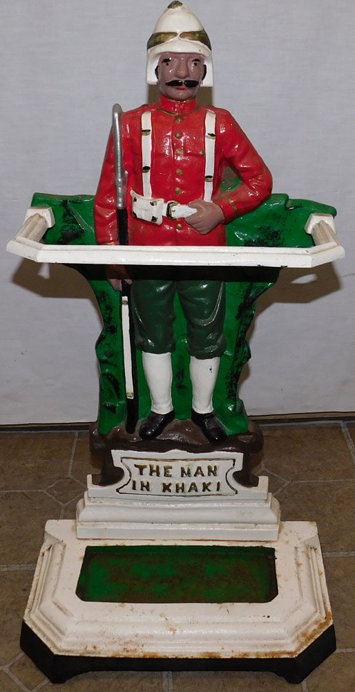 Painted Cast Iron " The Man In Khaki " Umbrella Stand: Painted Cast Iron " The Man In Khaki " Umbrella Stand. 15" W 27" H ALL DESCRIPTIONS AND ANY CONDITION STATEMENT GIVEN BY LANGSTON AUCTION GALLERY ARE STRICTLY OPINIONS AND LANGSTON'S SHALL HAVE NO RES