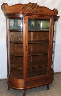 Antique Tiger Oak Carved Bow Front China Cabinet: Antique Tiger Oak Carved Bow Front China Cabinet. 49 3/4" W 16" D 71 1/2" H ALL DESCRIPTIONS AND ANY CONDITION STATEMENT GIVEN BY LANGSTON AUCTION GALLERY ARE STRICTLY OPINIONS AND LANGSTON'S SHALL