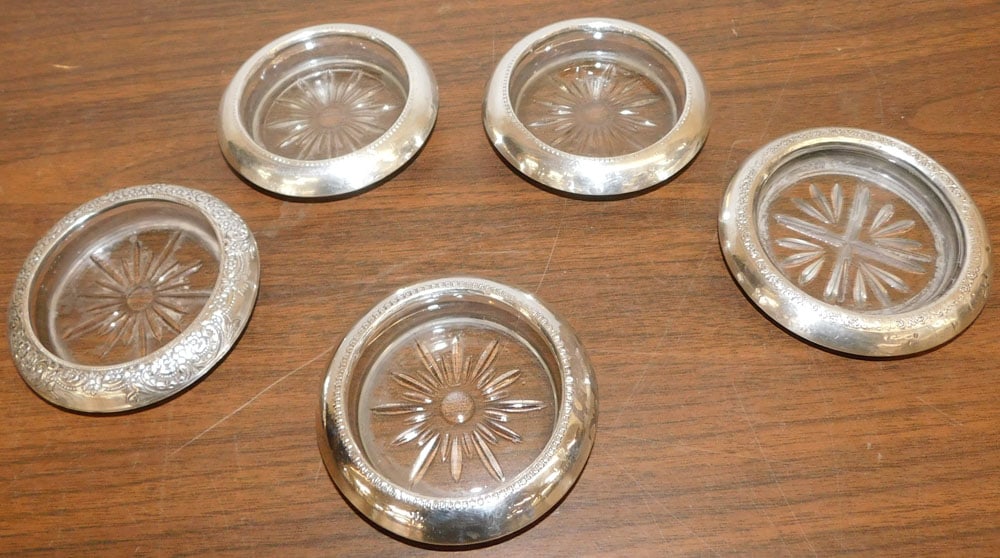 Lot 5 Sterling Rimmed Coasters: Lot 5 Sterling Rimmed Coasters. ALL DESCRIPTIONS AND ANY CONDITION STATEMENT GIVEN BY LANGSTON AUCTION GALLERY ARE STRICTLY OPINIONS AND LANGSTON'S SHALL HAVE NO RESPONSIBILITY FOR ERRORS OR OMISSIONS