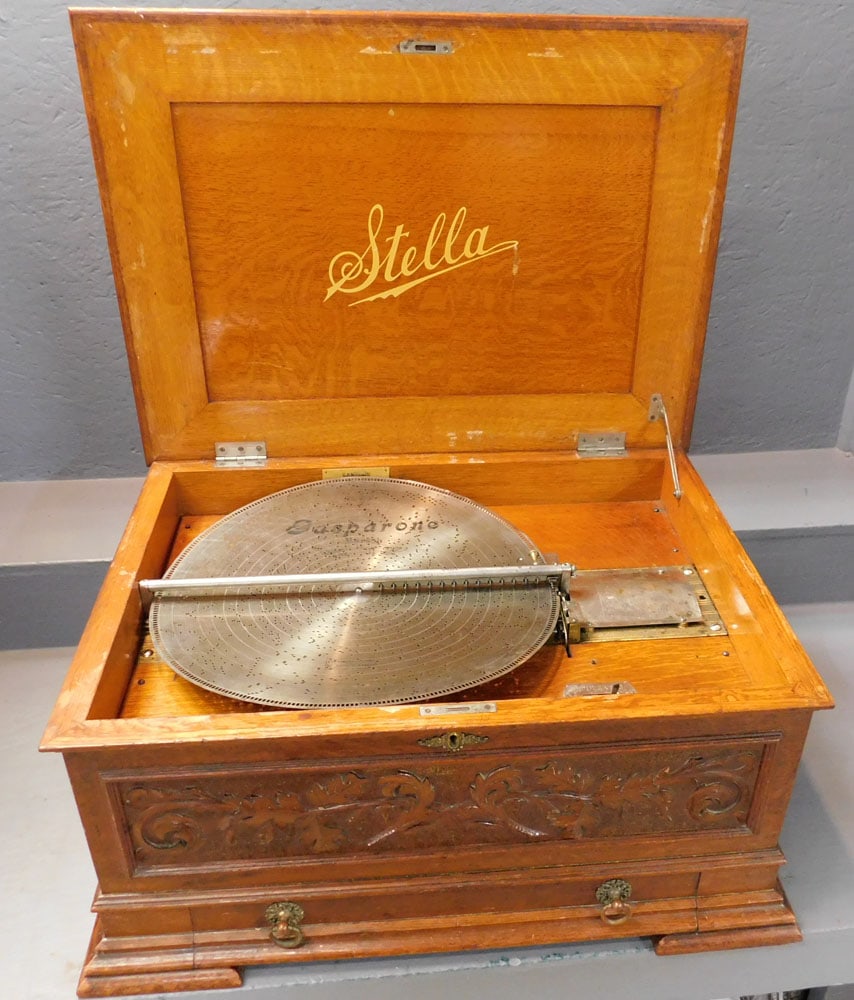 Antique Oak Stella Music Box With Eleven Discs (Working): Antique Oak Stella Music Box With Eleven Discs (Working). 28 1/4" W 21" D 13 1/4" H ALL DESCRIPTIONS AND ANY CONDITION STATEMENT GIVEN BY LANGSTON AUCTION GALLERY ARE STRICTLY OPINIONS AND LANGSTON'S 