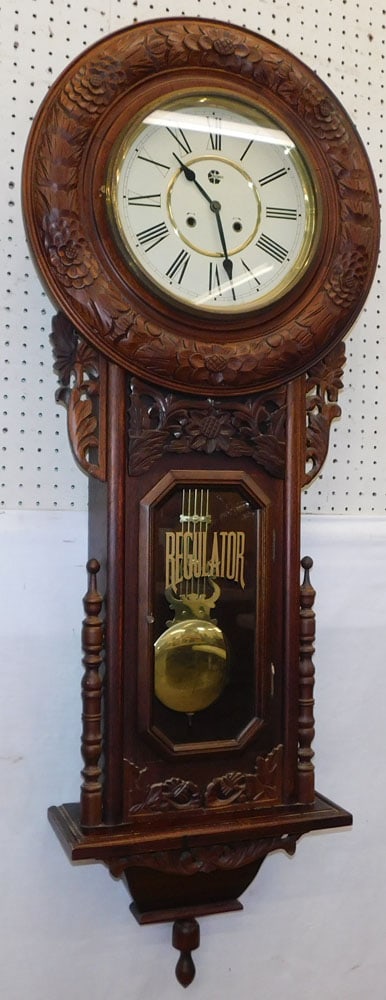 Carved Mahogany Wall Regulator: Carved Mahogany Wall Regulator. 55" H ALL DESCRIPTIONS AND ANY CONDITION STATEMENT GIVEN BY LANGSTON AUCTION GALLERY ARE STRICTLY OPINIONS AND LANGSTON'S SHALL HAVE NO RESPONSIBILITY FOR ERRORS OR OMI