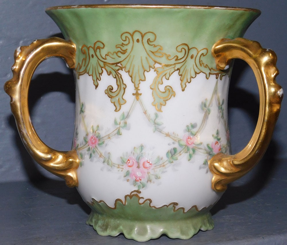 French Hand Painted Porcelain Loving Cup: French Hand Painted Porcelain Loving Cup. 5 3/4" H ALL DESCRIPTIONS AND ANY CONDITION STATEMENT GIVEN BY LANGSTON AUCTION GALLERY ARE STRICTLY OPINIONS AND LANGSTON'S SHALL HAVE NO RESPONSIBILITY FOR 