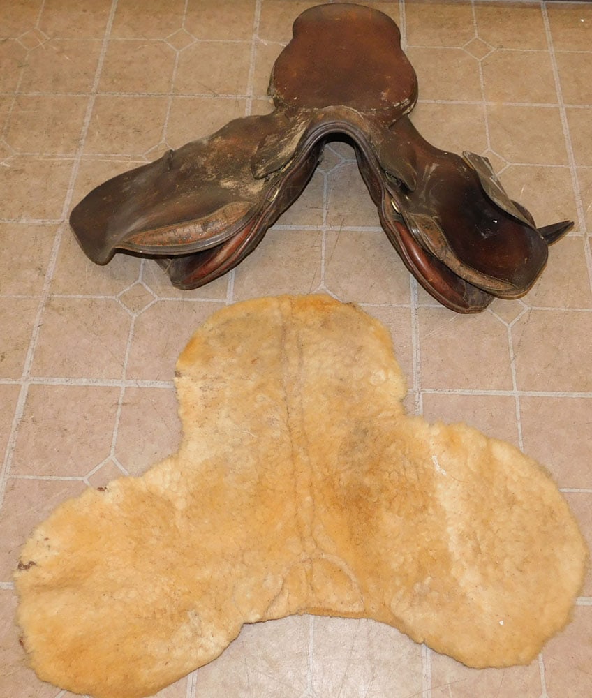 Leather Saddle: Leather Saddle. ALL DESCRIPTIONS AND ANY CONDITION STATEMENT GIVEN BY LANGSTON AUCTION GALLERY ARE STRICTLY OPINIONS AND LANGSTON'S SHALL HAVE NO RESPONSIBILITY FOR ERRORS OR OMISSIONS. THE ABSENCE OF