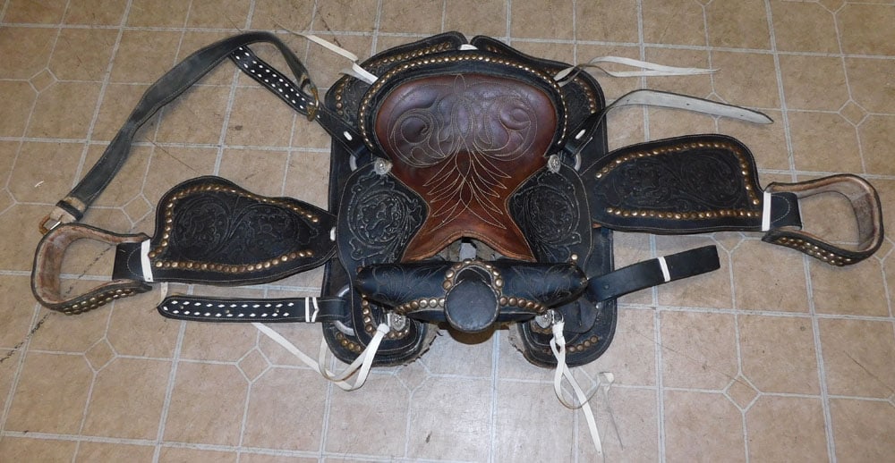 Leather Saddle: Leather Saddle. ALL DESCRIPTIONS AND ANY CONDITION STATEMENT GIVEN BY LANGSTON AUCTION GALLERY ARE STRICTLY OPINIONS AND LANGSTON'S SHALL HAVE NO RESPONSIBILITY FOR ERRORS OR OMISSIONS. THE ABSENCE OF