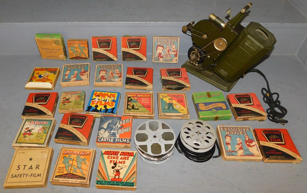 Vintage Excel Movie Projector with Cartoon Reels: Vintage Excel Movie Projector with Cartoon Reels . ALL DESCRIPTIONS AND ANY CONDITION STATEMENT GIVEN BY LANGSTON AUCTION GALLERY ARE STRICTLY OPINIONS AND LANGSTON'S SHALL HAVE NO RESPONSIBILITY FOR