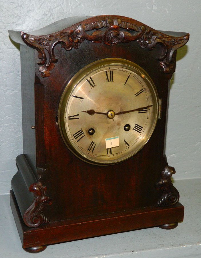 8 day walnut mantle clock w/rosette carving.: Eight day walnut mantle clock with rosette carving and bun feet. 10" x 12 1/2".