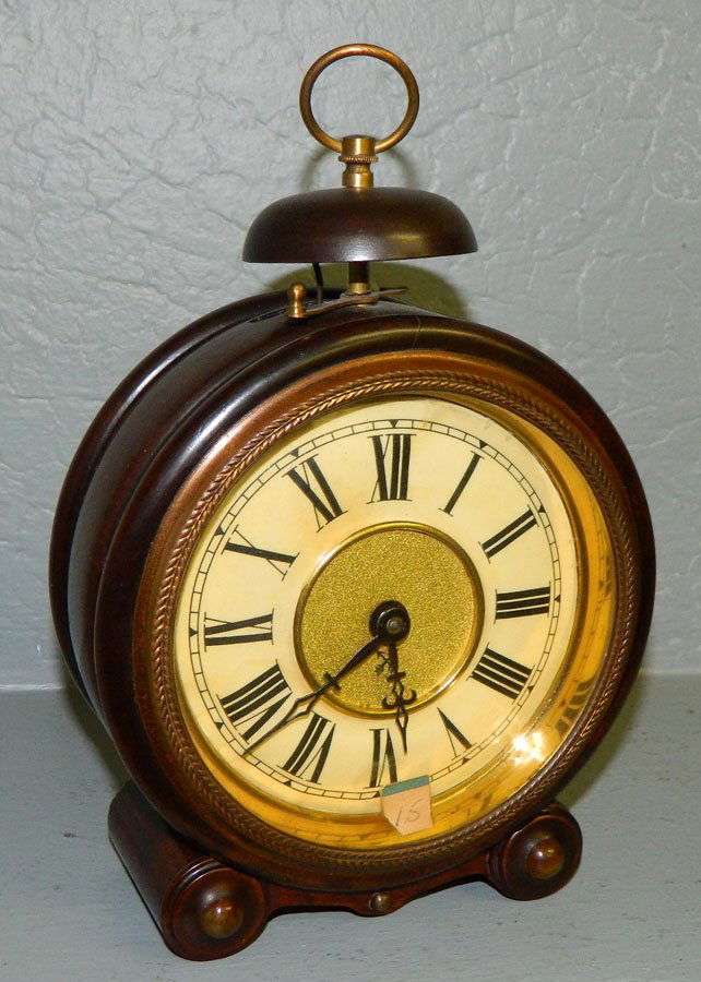 1 day German poplar shelf clock w/ shell holds.: One day German poplar shelf clock with wooden cylindrical shell holds. 5 3/4" diameter.(Like Big Ben)