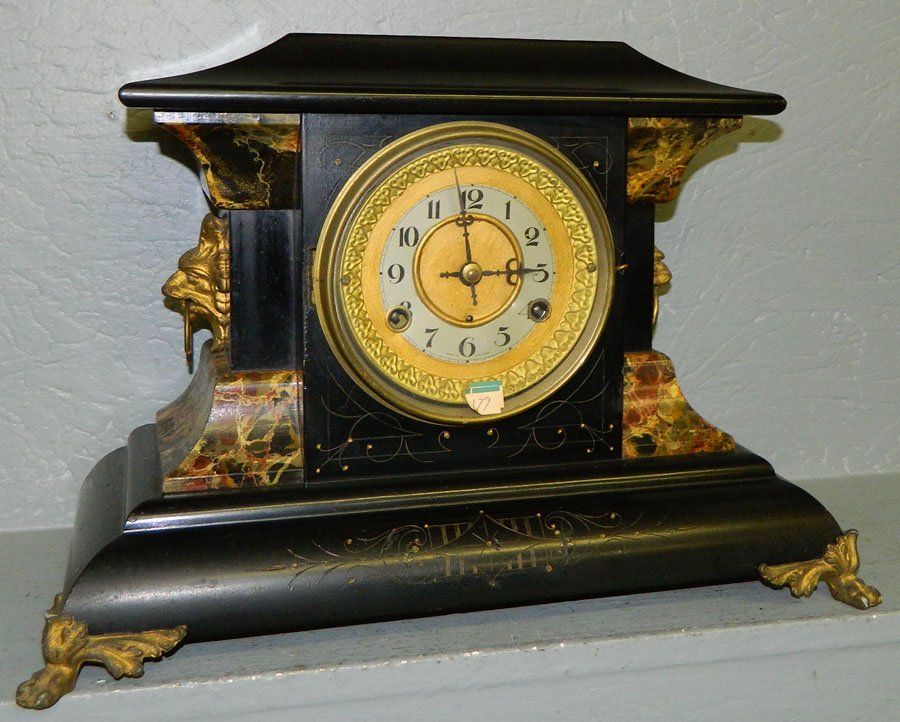 Adamantine 8 day mantle clock w/lion head detail: New Haven Adamantine eight day mantle clock with lions head detail. 17" x 12".