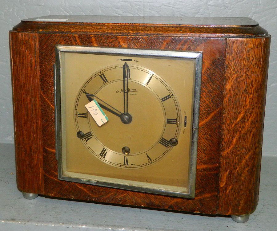 8 day oak Sir John Bennet clock w/chrome bezel: Eight day oak case chiming clock with chrome bezel. Dial reads "Sir John Bennett, London." 12" x 9 1/2".