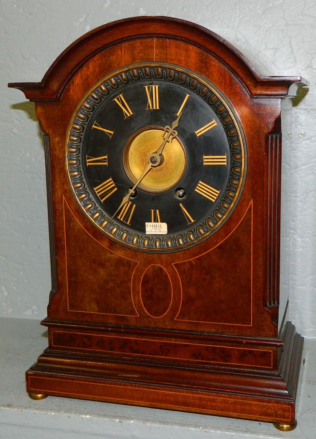 Mahogany inlaid mantle clock w/ marble dial.: Mahogany inlaid German tall mantle clock with marble dial and arch top. 10 1/2" x 12 1/2".