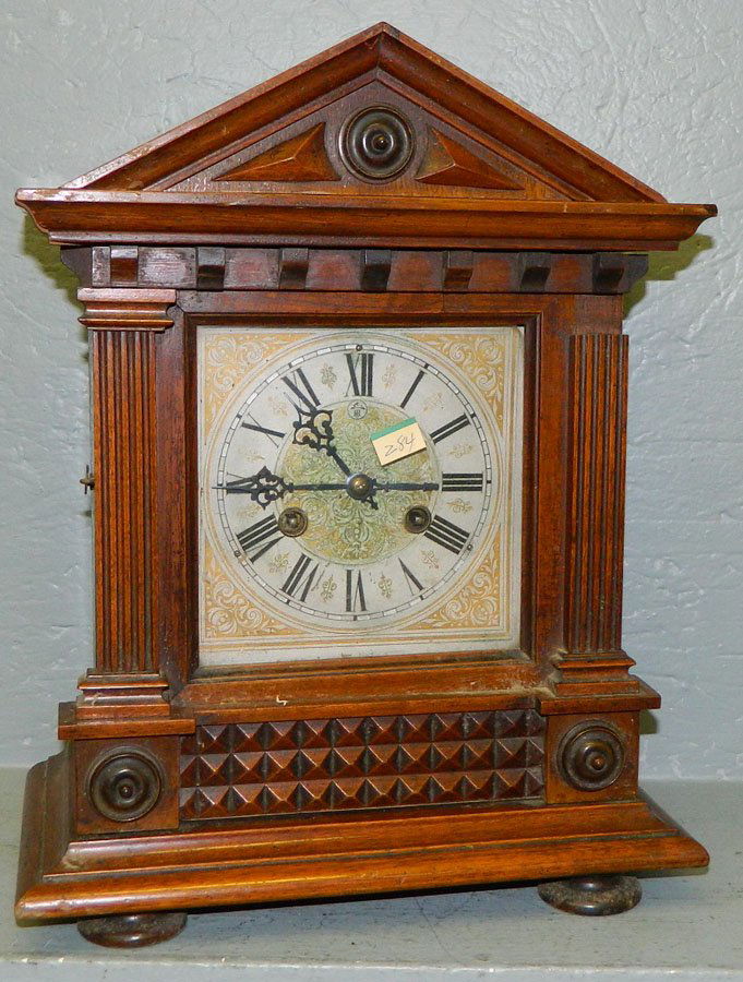 Oak 8 day clock w/columns & square dial.: German oak eight day clock with two columns, square dial and gable Gothic top. 12 1/2" x 15".