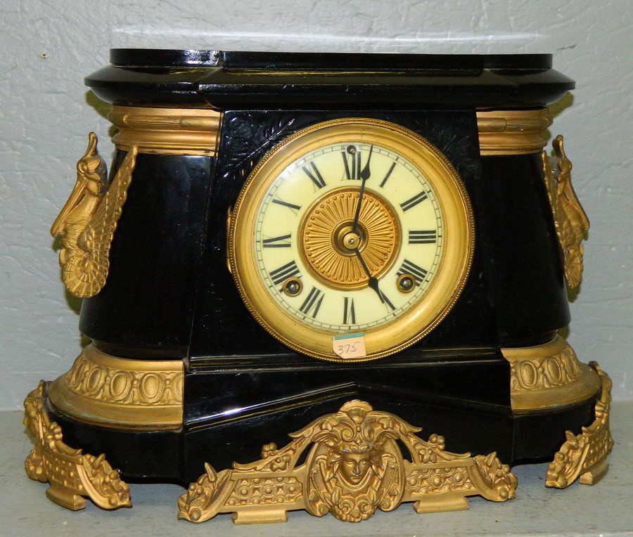 Ansonia 8 day clock w/pelican detail.: Ansonia black and gold painted eight day clock with porcelain dial and pelican detail. 15" x 11".
