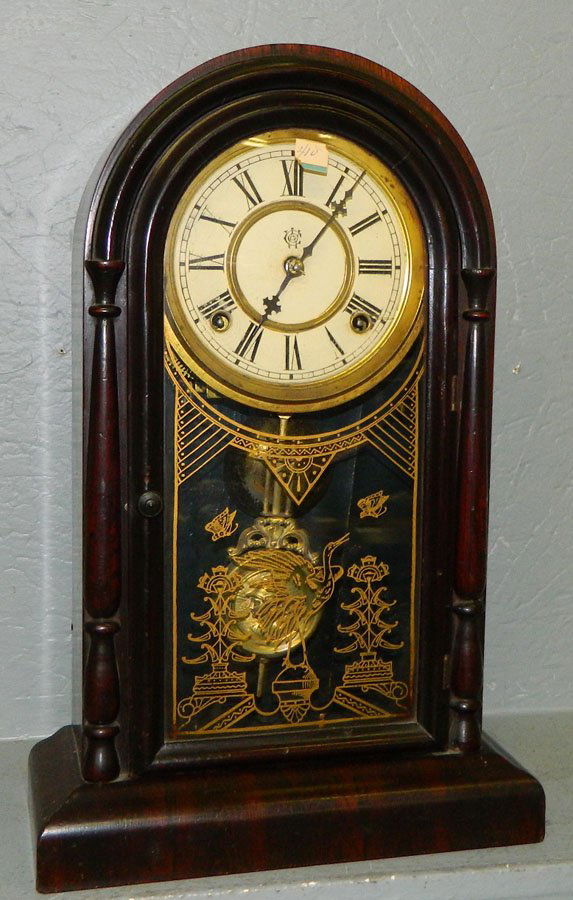 Waterbury 8 day rosewood Gothic style clock .: Waterbury eight day rosewood Gothic style clock with head on pendulum. 11 1/4" x 17 1/2".