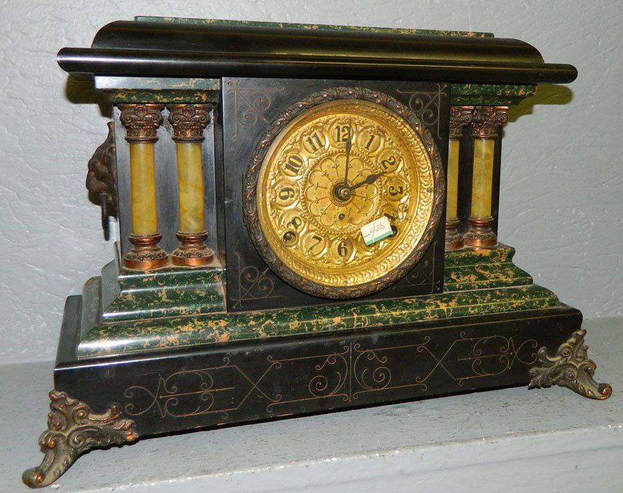 Seth Thomas 8 day mantle clock.: Seth Thomas eight day green and black Adamantine finish mantle clock with lions head detail and brass dial and feet. 17 1/2" x 11 1/2".