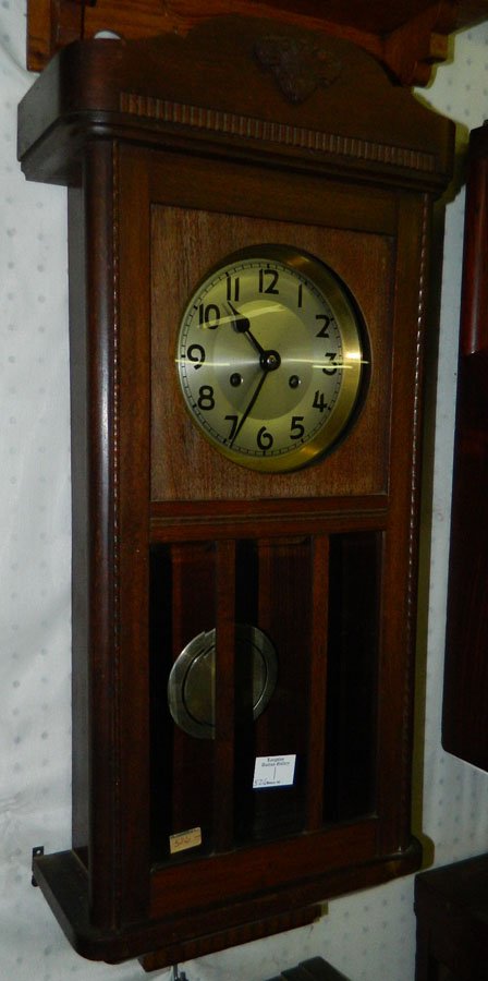 German walnut 8 day pendulum wall clock.: German fruit wood eight day pendulum wall clock with beveled glass panels. 14" x 30".