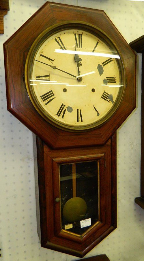 8 day Seth Thomas rosewood schoolhouse clock: Eight day Seth Thomas rosewood schoolhouse pendulum wall clock. 17" x 32".