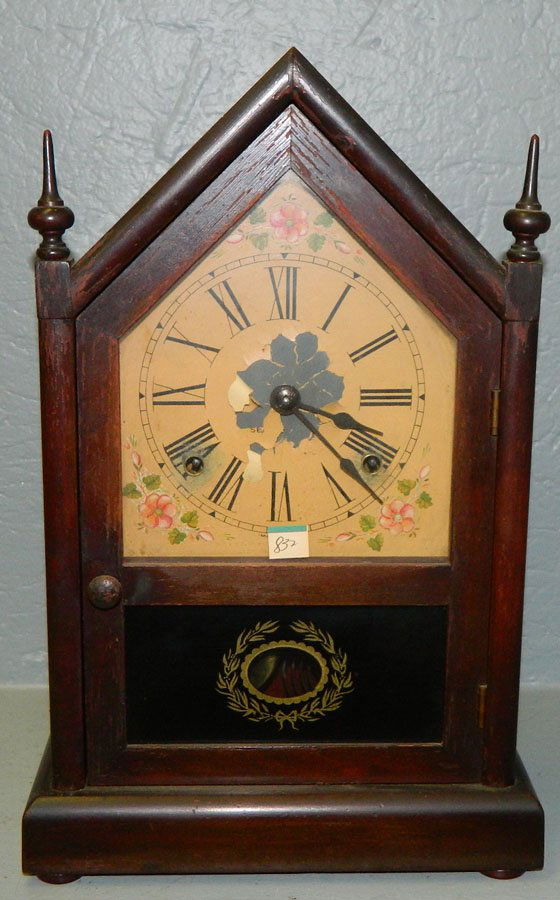 8 day Seth Thomas steeple clock w/ floral detail.: Eight day Seth Thomas steeple clock with painted dial and floral detail. Paint is flecking at the base. 9" x 14 1/2".