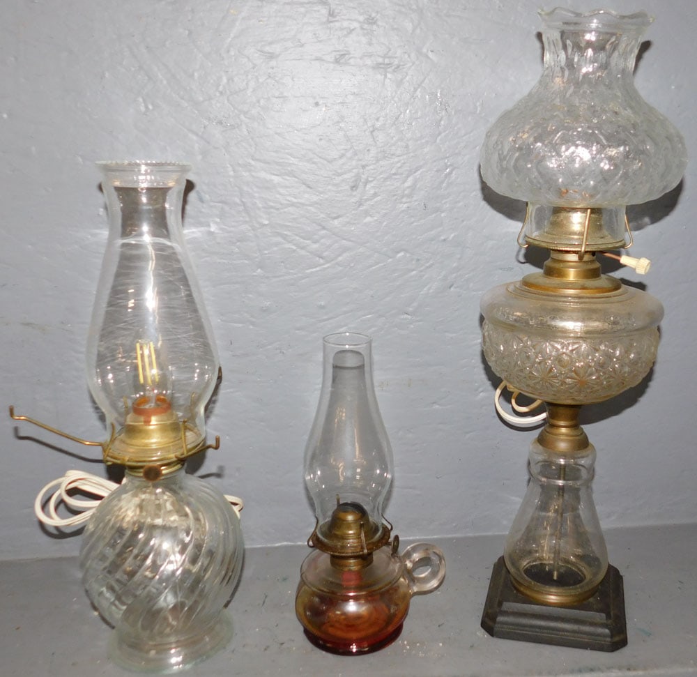 Three Glass Oil Lamps: Three Glass Oil Lamps. 19 1/4" H "ALL DESCRIPTIONS AND ANY CONDITION STATEMENT GIVEN BY LANGSTON AUCTION GALLERY ARE STRICTLY OPINIONS AND LANGSTON'S SHALL HAVE NO RESPONSIBILITY FOR ERRORS OR OMISSIO