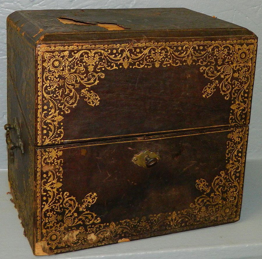 4 bottle Tantalus set w/ 7 cordial glasses & case: (4) bottle Tantalus set with (7) cordial glasses and leather covered case.