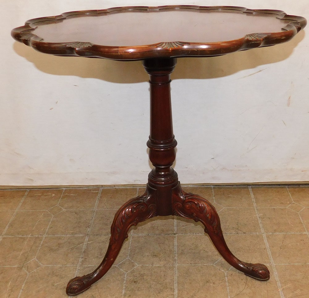 mahogany pie crust top tea table: mahogany pie crust top tea table. 27" Dia. 28 1/2" H "ALL DESCRIPTIONS AND ANY CONDITION STATEMENT GIVEN BY LANGSTON AUCTION GALLERY ARE STRICTLY OPINIONS AND LANGSTON'S SHALL HAVE NO RESPONSIBILITY F