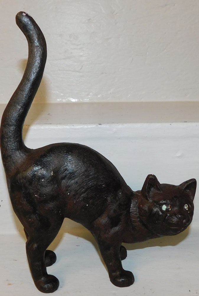 cast iron cat door stop: cast iron cat door stop. 10 1/2" H "ALL DESCRIPTIONS AND ANY CONDITION STATEMENT GIVEN BY LANGSTON AUCTION GALLERY ARE STRICTLY OPINIONS AND LANGSTON'S SHALL HAVE NO RESPONSIBILITY FOR ERRORS OR OMISS