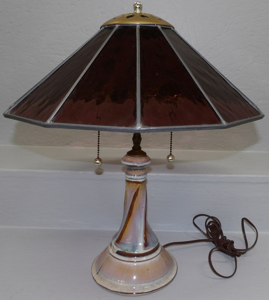 Leaded Amethyst Shade Table Lamp with Pottery Base: Leaded Amethyst Shade Table Lamp with Pottery Base. 19 1/2" H ALL DESCRIPTIONS AND ANY CONDITION STATEMENT GIVEN BY LANGSTON AUCTION GALLERY ARE STRICTLY OPINIONS AND LANGSTON'S SHALL HAVE NO RESPONSI
