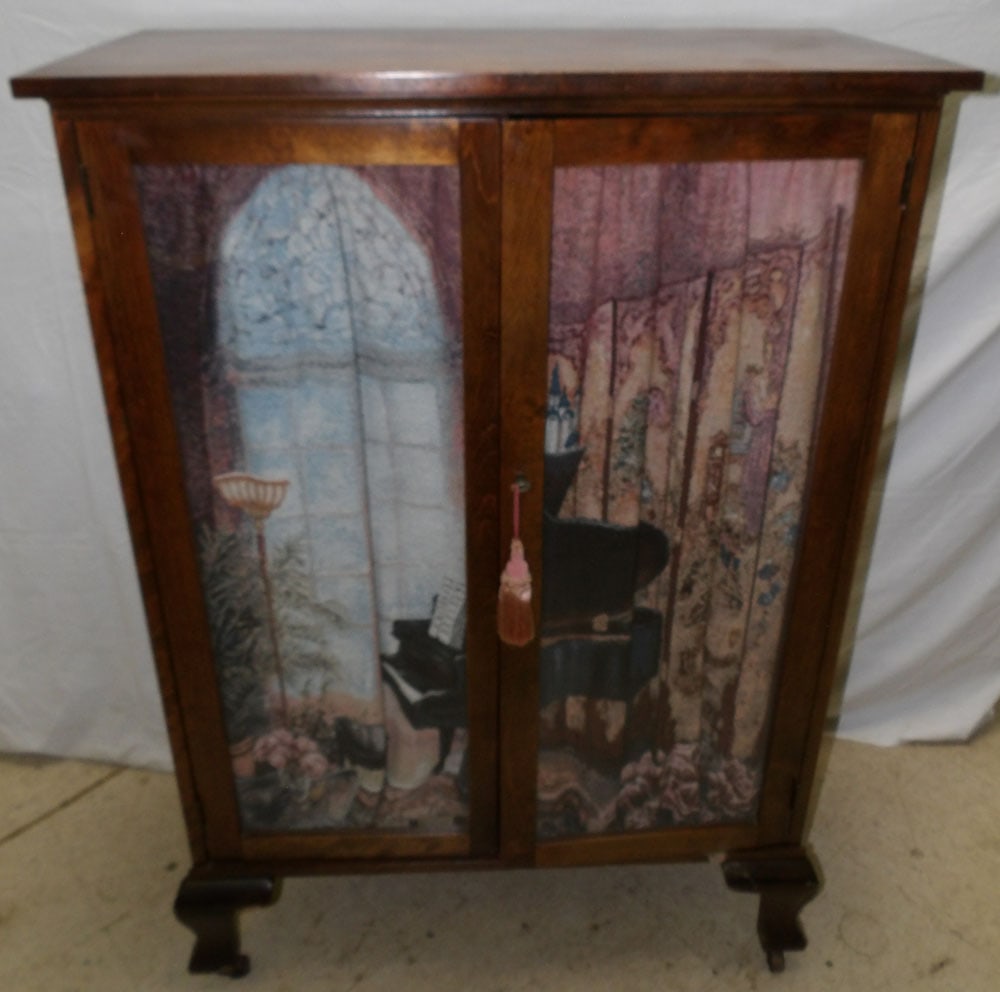 walnut glass door cabinet full of piano rolls: walnut glass door cabinet full of piano rolls. 32 1/2" W 15 1/4" D 47" H"ALL DESCRIPTIONS AND ANY CONDITION STATEMENT GIVEN BY LANGSTON AUCTION GALLERY ARE STRICTLY OPINIONS AND LANGSTON'S SHALL HAVE