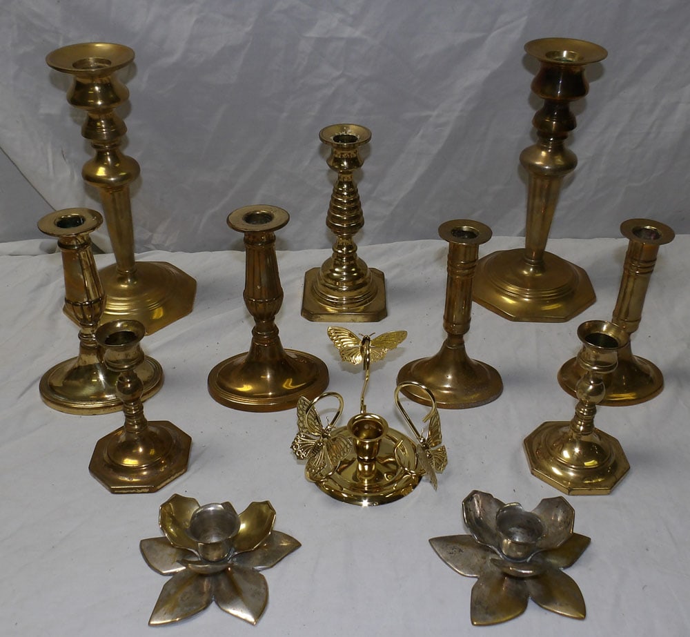 lot of brass candlesticks: lot of brass candlesticks. ALL DESCRIPTIONS AND ANY CONDITION STATEMENT GIVEN BY LANGSTON AUCTION GALLERY ARE STRICTLY OPINIONS AND LANGSTON'S SHALL HAVE NO RESPONSIBILITY FOR ERRORS OR OMISSIONS. THE