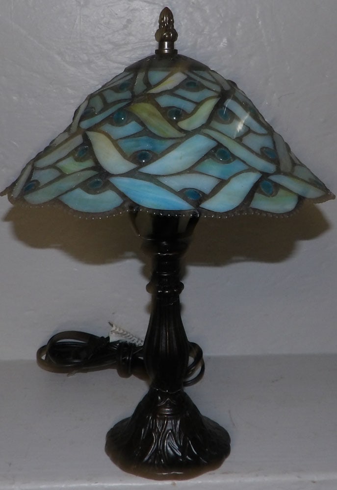 leaded stain glass tiffany style lamp: leaded stain glass tiffany style lamp. 13 1/2" H ALL DESCRIPTIONS AND ANY CONDITION STATEMENT GIVEN BY LANGSTON AUCTION GALLERY ARE STRICTLY OPINIONS AND LANGSTON'S SHALL HAVE NO RESPONSIBILITY FOR ER