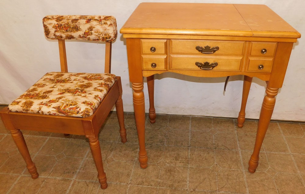 vintage maple cabinet sewing machine with chair: vintage maple cabinet sewing machine with chair. 27" W 19" D 32" H ALL DESCRIPTIONS AND ANY CONDITION STATEMENT GIVEN BY LANGSTON AUCTION GALLERY ARE STRICTLY OPINIONS AND LANGSTON'S SHALL HAVE NO RES