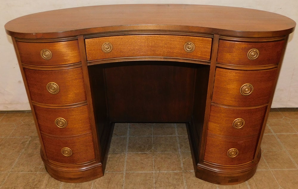 mahogany kidney shape desk: mahogany kidney shape desk. 46 3/4" W 24 1/2" D 29 1/2" H ALL DESCRIPTIONS AND ANY CONDITION STATEMENT GIVEN BY LANGSTON AUCTION GALLERY ARE STRICTLY OPINIONS AND LANGSTON'S SHALL HAVE NO RESPONSIBILI