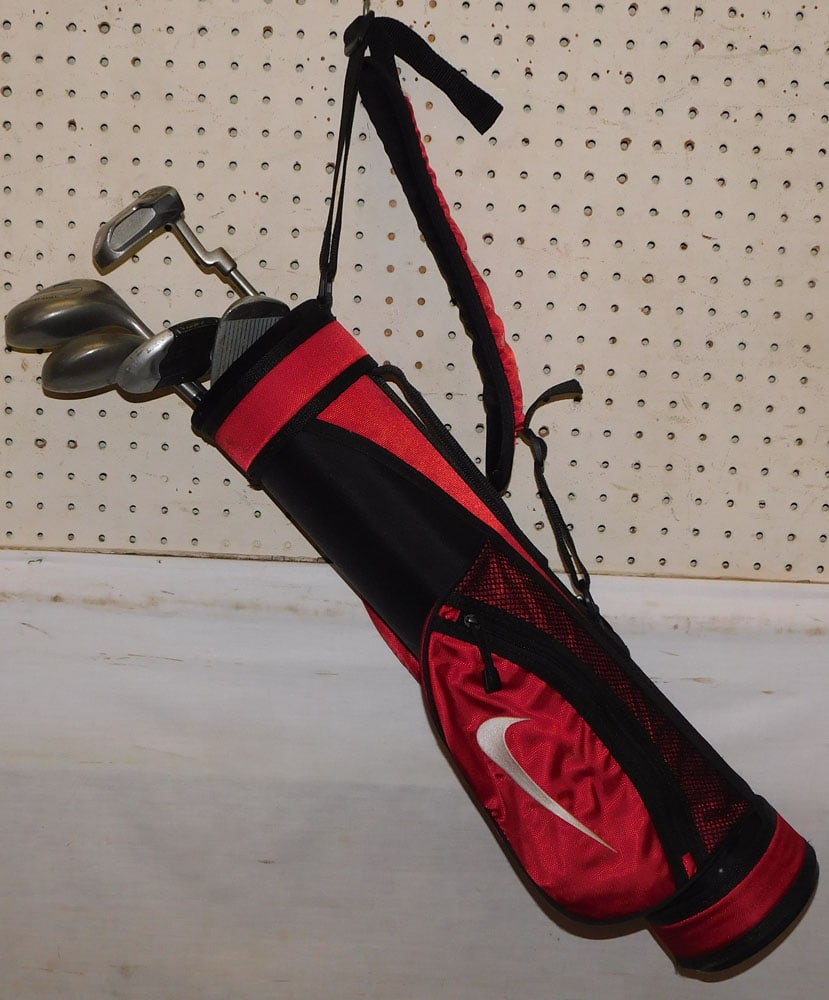 child's golf bag with clubs: child's golf bag with clubs. 28" H ALL DESCRIPTIONS AND ANY CONDITION STATEMENT GIVEN BY LANGSTON AUCTION GALLERY ARE STRICTLY OPINIONS AND LANGSTON'S SHALL HAVE NO RESPONSIBILITY FOR ERRORS OR OMISSI