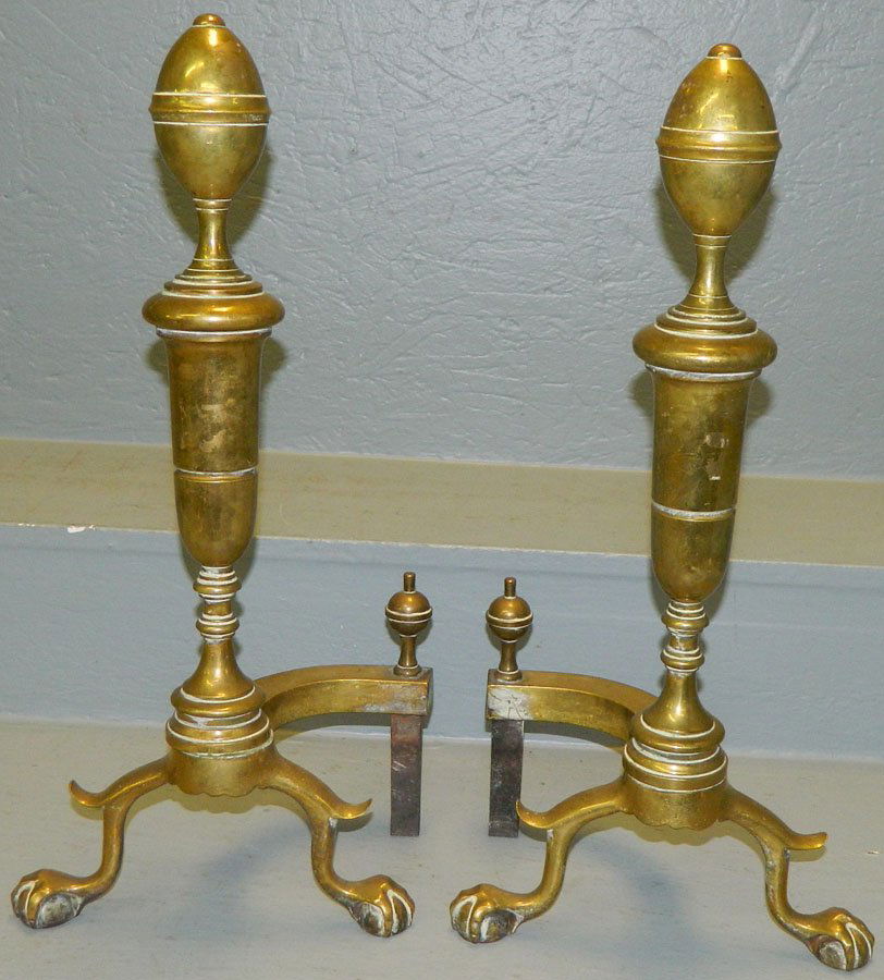 Pair of claw foot brass andirons.: Pair of claw foot brass andirons. 19 1/2" tall.