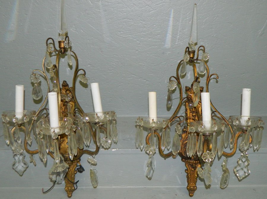 Pair of crystal and bronze wall sconces.: Pair of crystal and bronze wall sconces. 24" tall.