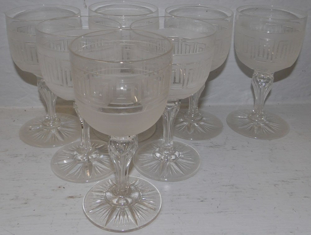 Seven Greek key cut wine glasses: Seven Greek key cut wine glasses. 5 1/2" H "ALL DESCRIPTIONS AND ANY CONDITION STATEMENT GIVEN BY LANGSTON AUCTION GALLERY ARE STRICTLY OPINIONS AND LANGSTON'S SHALL HAVE NO RESPONSIBILITY FOR ERRORS 