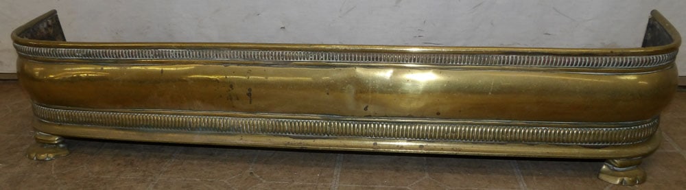 antique brass fireplace fender: antique brass fireplace fender. 48" W 8 1/2" H "ALL DESCRIPTIONS AND ANY CONDITION STATEMENT GIVEN BY LANGSTON AUCTION GALLERY ARE STRICTLY OPINIONS AND LANGSTON'S SHALL HAVE NO RESPONSIBILITY FOR ERR