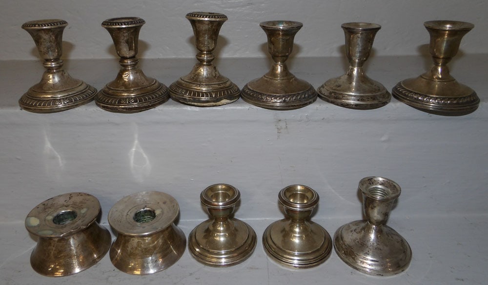 11 Sterling Weighted Candlesticks: 11 Sterling Weighted Candlesticks. Up to 3 1/2" H "ALL DESCRIPTIONS AND ANY CONDITION STATEMENT GIVEN BY LANGSTON AUCTION GALLERY ARE STRICTLY OPINIONS AND LANGSTON'S SHALL HAVE NO RESPONSIBILITY FOR