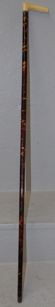 Faux Tortoise Shell & Bone Handle Walking Stick: Faux Tortoise Shell & Bone Handle Walking Stick . 35 1/4" L "ALL DESCRIPTIONS AND ANY CONDITION STATEMENT GIVEN BY LANGSTON AUCTION GALLERY ARE STRICTLY OPINIONS AND LANGSTON'S SHALL HAVE NO RESPONSIB