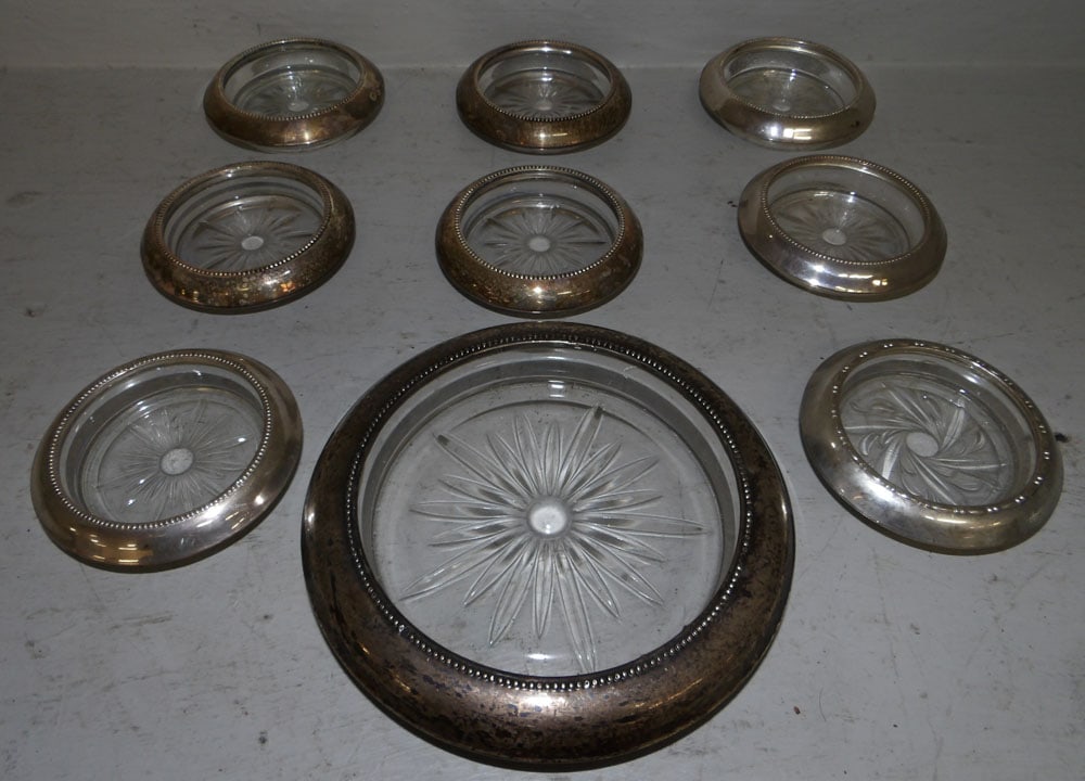 Lot of Sterling Rimmed Coasters: Lot of Sterling Rimmed Coasters. Up to 7" Dia. "ALL DESCRIPTIONS AND ANY CONDITION STATEMENT GIVEN BY LANGSTON AUCTION GALLERY ARE STRICTLY OPINIONS AND LANGSTON'S SHALL HAVE NO RESPONSIBILITY FOR ERR